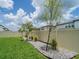 Manicured backyard with lush green grass, a rock garden, and a privacy fence at 7700 Bronze Oak Dr, Wesley Chapel, FL 33545