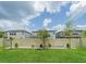 Spacious backyard with healthy green grass and a full privacy fence at 7700 Bronze Oak Dr, Wesley Chapel, FL 33545