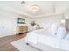 Bright bedroom with a modern chandelier, a TV, two closets, and a small desk at 7700 Bronze Oak Dr, Wesley Chapel, FL 33545
