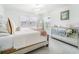 Cozy bedroom with neutral decor, a plush bed, and a mirrored dresser at 7700 Bronze Oak Dr, Wesley Chapel, FL 33545
