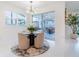 Bright dining area with modern chandelier, round table, and sliding door to the patio at 7700 Bronze Oak Dr, Wesley Chapel, FL 33545