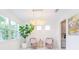Bright dining area featuring modern light fixture, comfortable seating, and elegant decor at 7700 Bronze Oak Dr, Wesley Chapel, FL 33545