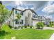 Attractive two-story home with stone accents, blue shutters, and a well-manicured lawn at 7700 Bronze Oak Dr, Wesley Chapel, FL 33545