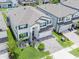 Aerial view of the white home showing the blue shutters and brick paver driveway at 7700 Bronze Oak Dr, Wesley Chapel, FL 33545
