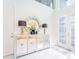 Elegant foyer with a decorative mirror, accent table, and stylish lighting at 7700 Bronze Oak Dr, Wesley Chapel, FL 33545