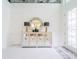 Bright and airy foyer with a mirrored console table and decorative accents at 7700 Bronze Oak Dr, Wesley Chapel, FL 33545