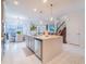 Open floor plan boasts kitchen with island, stainless appliances, and eat-in dining area at 7700 Bronze Oak Dr, Wesley Chapel, FL 33545
