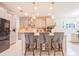 Bright kitchen featuring a spacious island with pendant lighting and stainless steel appliances at 7700 Bronze Oak Dr, Wesley Chapel, FL 33545