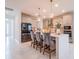 Modern kitchen with an island, stainless steel appliances, and elegant bar stool seating at 7700 Bronze Oak Dr, Wesley Chapel, FL 33545