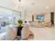 Open-concept living area with stylish dining set and a modern living room at 7700 Bronze Oak Dr, Wesley Chapel, FL 33545