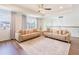 Upstairs living room with plush sofas, tray ceiling, and natural light at 7700 Bronze Oak Dr, Wesley Chapel, FL 33545