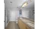 A bathroom features double sinks, granite counters, and tiled floors at 777 N Ashley Dr # 1903, Tampa, FL 33602