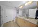 A bathroom features double sinks, granite counters, and a glass shower at 777 N Ashley Dr # 1903, Tampa, FL 33602