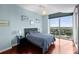 Serene bedroom with a large window showcasing a scenic city view, complete with stylish decor at 777 N Ashley Dr # 1903, Tampa, FL 33602