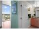 This hallway has light-colored walls with doors leading to the bathroom and an adjacent bedroom with a city view at 777 N Ashley Dr # 1903, Tampa, FL 33602