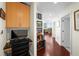 Hallway with wood floors, office space, and wine storage leading to living area at 777 N Ashley Dr # 1903, Tampa, FL 33602