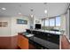 Modern kitchen featuring granite counters, stainless steel appliances, and access to a stunning living area with city views at 777 N Ashley Dr # 1903, Tampa, FL 33602