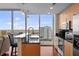 Modern kitchen with granite countertops, stainless appliances, and panoramic views through large windows at 777 N Ashley Dr # 1903, Tampa, FL 33602