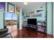 Inviting living room boasting a flat-screen TV, shelving, and beautiful hardwood floors with a city view at 777 N Ashley Dr # 1903, Tampa, FL 33602