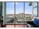 Bright living room featuring a city view from a large window and comfortable seating with hardwood floors at 777 N Ashley Dr # 1903, Tampa, FL 33602