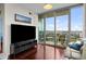 Modern living room with a mounted TV and sliding glass doors to a balcony with city views at 777 N Ashley Dr # 1903, Tampa, FL 33602
