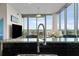Bright and airy living room boasts floor-to-ceiling windows with panoramic city views and modern finishes at 777 N Ashley Dr # 1903, Tampa, FL 33602