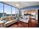 Stylish living room with floor-to-ceiling windows, hardwood floors, and modern furniture, offering a city view at 777 N Ashley Dr # 1903, Tampa, FL 33602