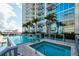 Luxury high-rise building featuring a beautiful pool and hot tub area with a stunning city view at 777 N Ashley Dr # 1903, Tampa, FL 33602