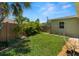 Lush backyard with tropical landscaping, a privacy fence, and a well-maintained lawn at 791 66Th S Ave, St Petersburg, FL 33705