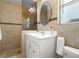 Bathroom featuring a glass enclosed shower, white vanity with an oval mirror and tiled walls at 791 66Th S Ave, St Petersburg, FL 33705