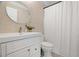 Bathroom featuring neutral tile, a white vanity and a round mirror at 791 66Th S Ave, St Petersburg, FL 33705