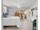 Bright bedroom with white bedding, tile floors, and access to an ensuite bathroom and outdoor space at 791 66Th S Ave, St Petersburg, FL 33705