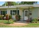 Charming front porch with decorative metal supports and landscaped garden, giving a welcoming curb appeal at 791 66Th S Ave, St Petersburg, FL 33705