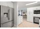 Modern kitchen with stainless steel refrigerator, built in oven, and open to the dining area for easy access at 791 66Th S Ave, St Petersburg, FL 33705