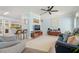 Inviting living room featuring mid century modern decor, light blue walls, and a ceiling fan for comfortable living at 791 66Th S Ave, St Petersburg, FL 33705