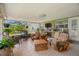 Relaxing sunroom with seating, a bar area, and plenty of natural light and greenery at 791 66Th S Ave, St Petersburg, FL 33705