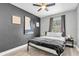This bedroom features a ceiling fan, neutral walls, and a large window for ample natural light at 8108 E 19Th Ave, Tampa, FL 33619