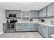 Charming kitchen with gray cabinets, stainless appliances, and laminate countertops at 8108 E 19Th Ave, Tampa, FL 33619