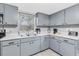 Well-lit kitchen featuring ample storage, stainless appliances, and laminate countertops at 8108 E 19Th Ave, Tampa, FL 33619
