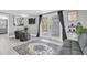 This living room is bright with backyard access, comfy seating, leafy plants and unique wall decor at 8108 E 19Th Ave, Tampa, FL 33619