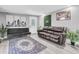 The living room features neutral walls, two sofas, a leafy green wall decoration and backyard access at 8108 E 19Th Ave, Tampa, FL 33619