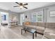 Neutral living room featuring a gray sectional sofa, bright windows, and stylish decor at 8108 E 19Th Ave, Tampa, FL 33619