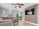 Bright living room with wood accent wall, recessed lighting, and neutral gray walls at 8108 E 19Th Ave, Tampa, FL 33619