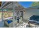 This covered patio is perfect for entertaining with a gas BBQ, cozy wicker furniture and string lights at 8108 E 19Th Ave, Tampa, FL 33619
