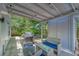 This covered patio with wicker furniture and a BBQ is perfect for gatherings with Gathering and friends at 8108 E 19Th Ave, Tampa, FL 33619