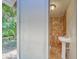 Enjoy this outdoor shower that features brown tiling, a vessel sink, and backyard access at 8108 E 19Th Ave, Tampa, FL 33619
