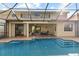 Inviting backyard with a pool, patio, seating area, and screened enclosure, ideal for outdoor living at 8358 Dunham Station Dr, Tampa, FL 33647