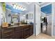 Well-lit bathroom has a granite countertop, tiled floor, and blue painted ceiling at 8358 Dunham Station Dr, Tampa, FL 33647