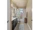 Clean bathroom with a single sink vanity, bathtub-shower combo, and neutral-colored tile at 8358 Dunham Station Dr, Tampa, FL 33647