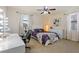 Bright bedroom featuring a vanity area and comfortable bed with natural light at 8358 Dunham Station Dr, Tampa, FL 33647